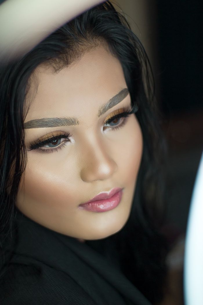 Close-up portrait of a beautiful Asian woman with elegant makeup.